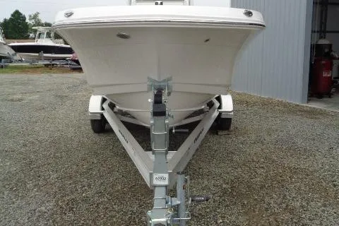 Slide: The Image of 2025 Robalo R202 Explorer boat on trailer, front view, parked on gravel. - 26
