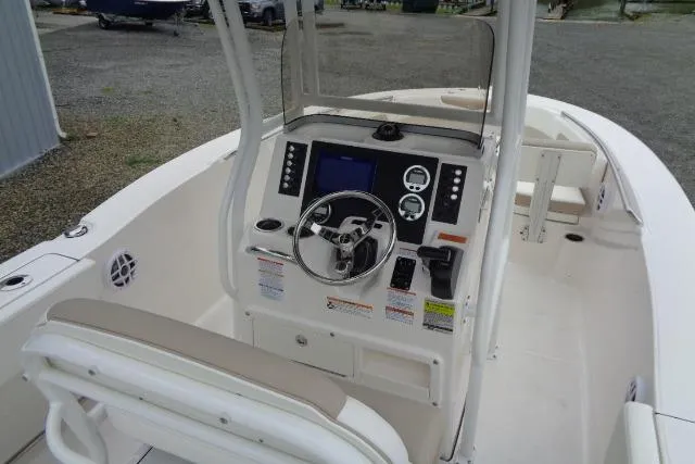 Slide: The Image of 2025 Robalo R202 Explorer boat cockpit with steering wheel and control panel. - 30