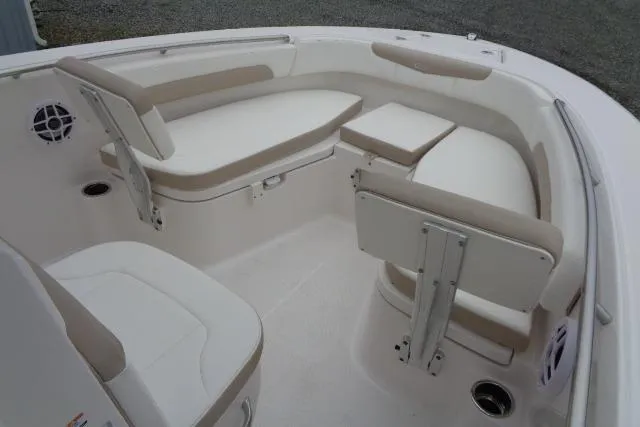 Slide: The Image of 2025 Robalo R202 Explorer boat interior with cushioned seating and storage compartments. - 31