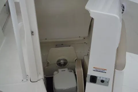 Slide: The Image of 2025 Robalo R202 Explorer boat interior with compact marine toilet. - 33