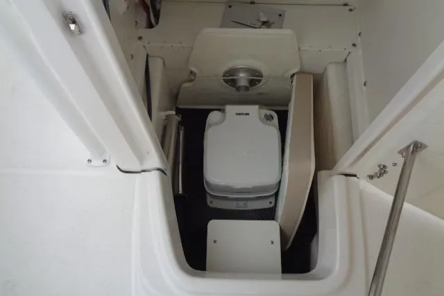 Slide: The Image of 2025 Robalo R202 Explorer boat interior with compact marine toilet. - 34