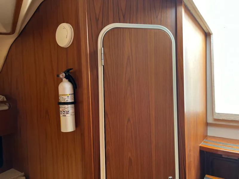 Slide: The Image of Interior of 1998 Luhrs 40 Open boat with wooden paneling and fire extinguisher. - 10