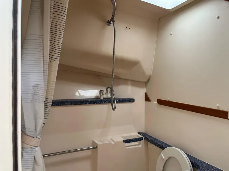 Slide: The Image of 1998 Luhrs 40 Open yacht bathroom with shower and toilet. - 12