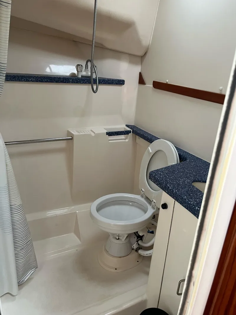 Slide: The Image of 1998 Luhrs 40 Open yacht bathroom with shower and toilet. - 14