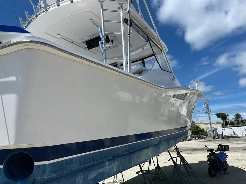 Slide: The Image of 1998 Luhrs 40 Open boat on stands, clear sky background. - 2