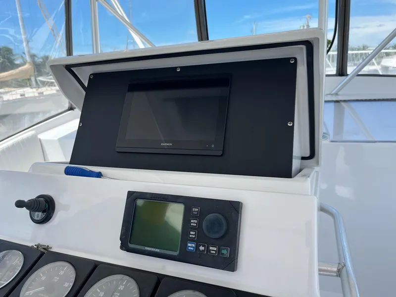 Slide: The Image of 1998 Luhrs 40 Open boat dashboard with navigation equipment and gauges. - 4