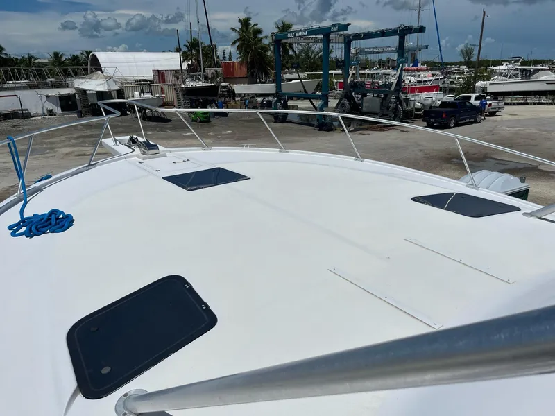 Slide: The Image of 1998 Luhrs 40 Open yacht deck view at marina with clear sky. - 7
