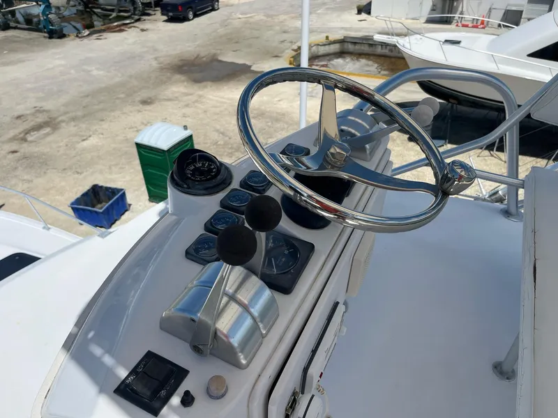 Slide: The Image of 1998 Luhrs 40 Open boat helm with steering wheel and controls. - 8