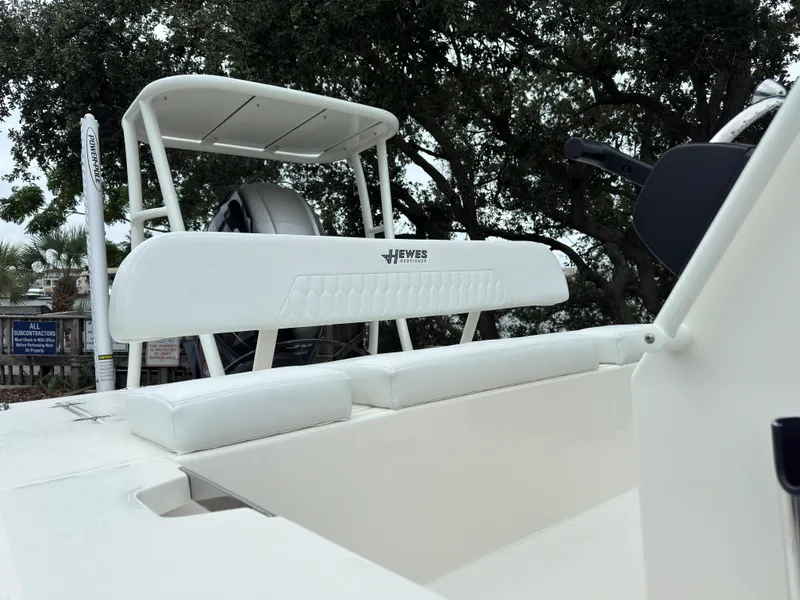 Slide: The Image of 2025 Hewes 16 Redfisher boat, white seating, outdoor setting. - 13