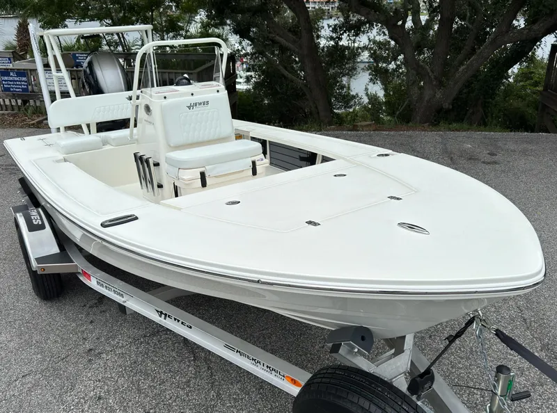 Slide: The Image of 2025 Hewes 16 Redfisher boat on trailer, parked outdoors. - 2