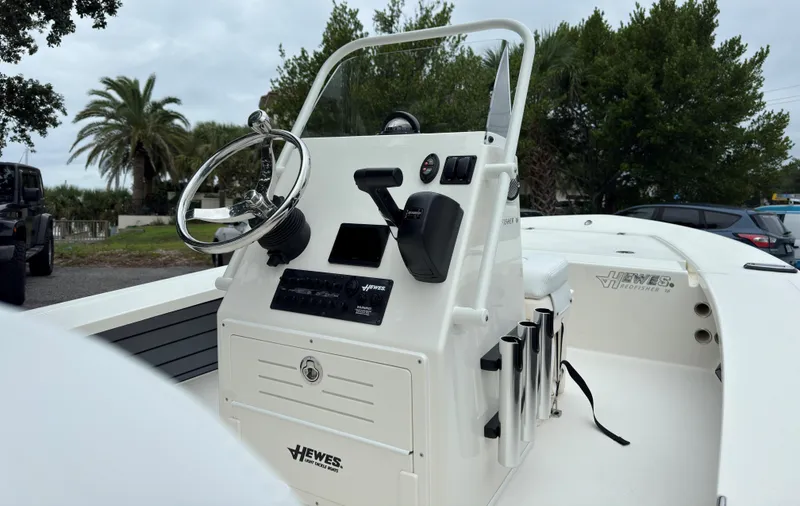 Slide: The Image of 2025 Hewes 16 Redfisher boat console with steering wheel and controls. - 9