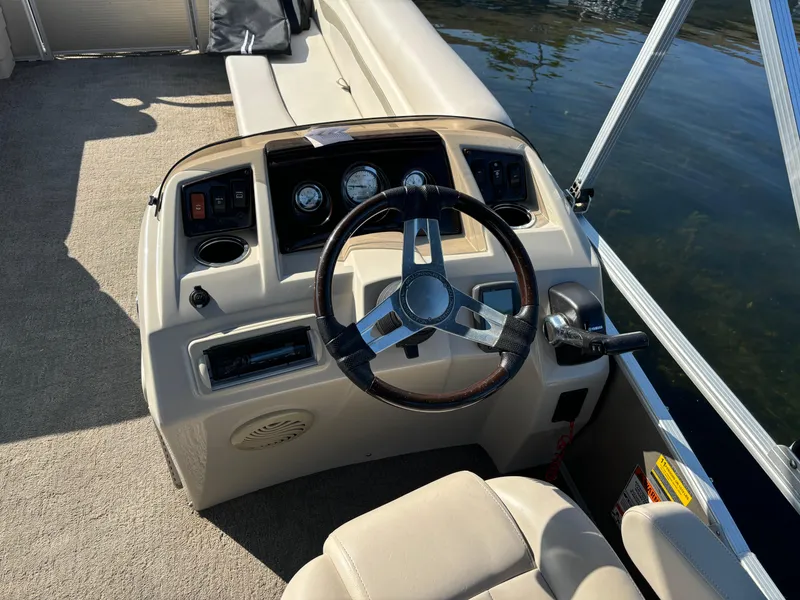Slide: The Image of Steering console of a 2014 Bennington 24 SSLX pontoon boat with gauges and controls. - 3