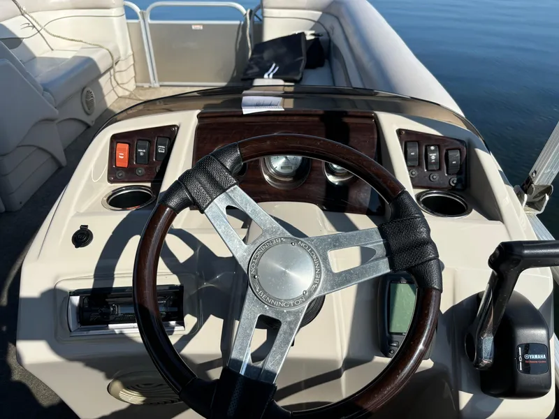 Slide: The Image of 2014 Bennington 24 SSLX boat dashboard with steering wheel and controls. - 8