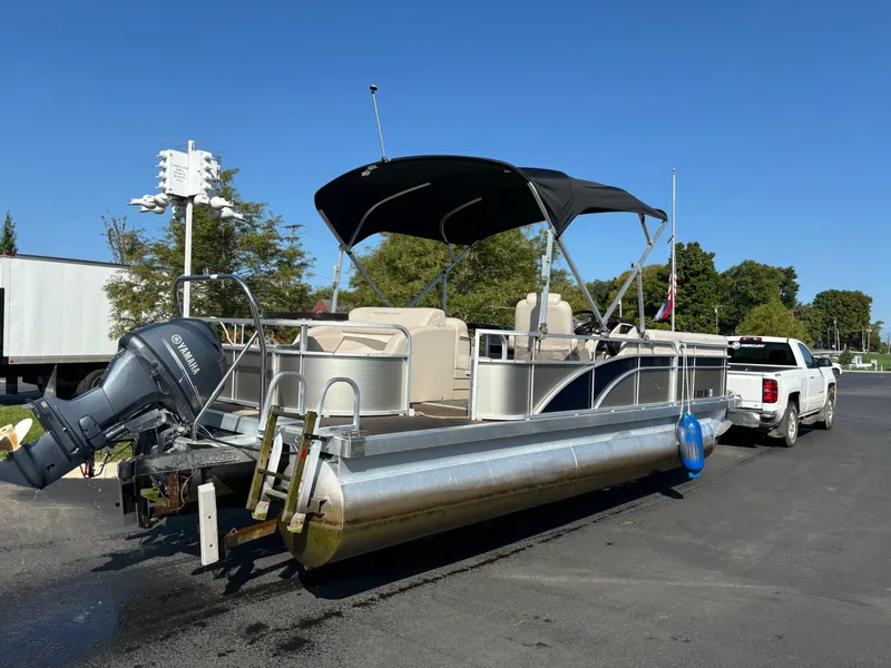 Slide: The Image of 2014 Bennington 24 SSLX pontoon boat with canopy, parked on a trailer. - 9