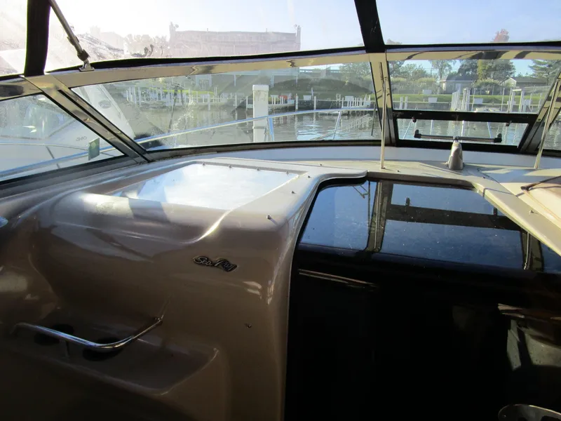 Slide: The Image of Interior view of 2001 Sea Ray 340 Amberjack boat cockpit with marina background. - 10