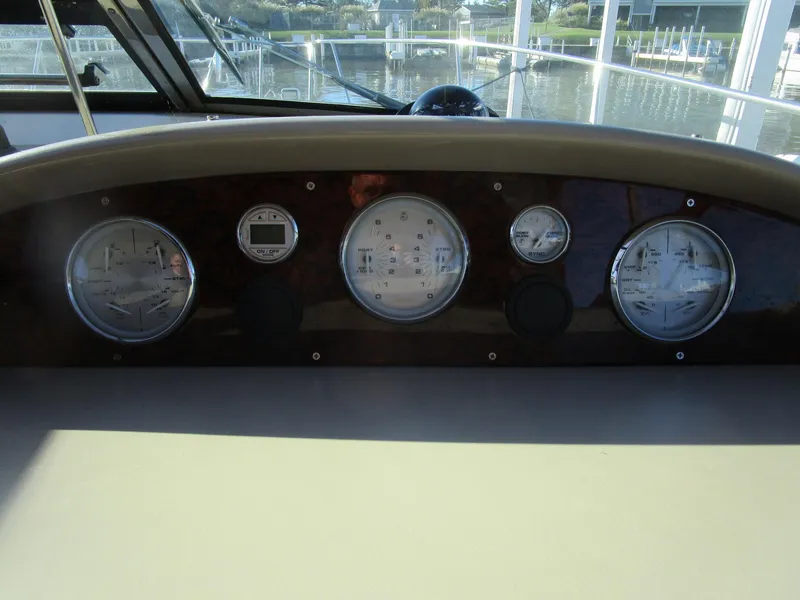 Slide: The Image of Dashboard of a 2001 Sea Ray 340 Amberjack boat with gauges and controls. - 11