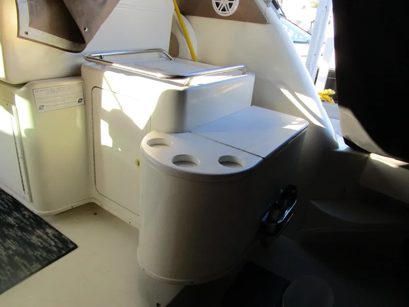 Slide: The Image of Interior of 2001 Sea Ray 340 Amberjack boat with storage and cup holders. - 15
