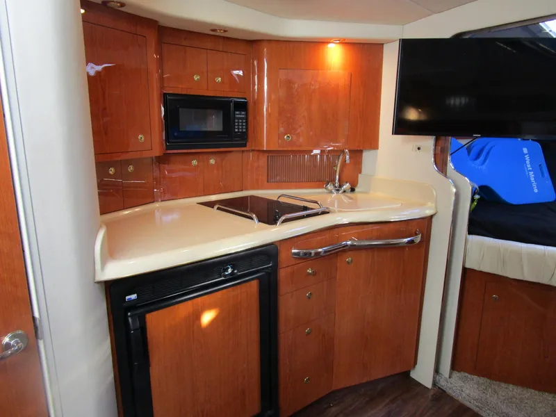 Slide: The Image of Luxurious 2001 Sea Ray 340 Amberjack yacht kitchen with wood cabinetry and modern appliances. - 16