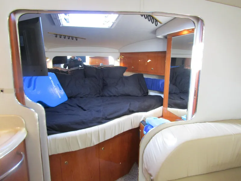 Slide: The Image of Interior cabin of 2001 Sea Ray 340 Amberjack with cozy bed and wooden cabinetry. - 17