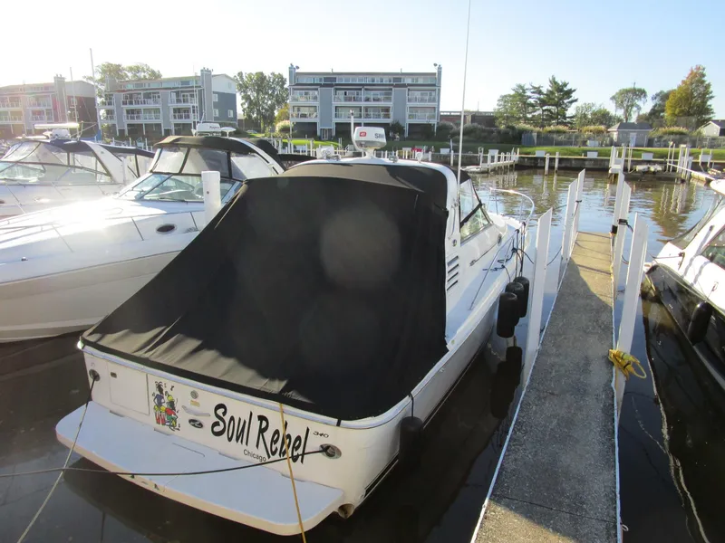 Slide: The Image of 2001 Sea Ray 340 Amberjack docked, covered, with "Soul Rebel" name visible. - 2