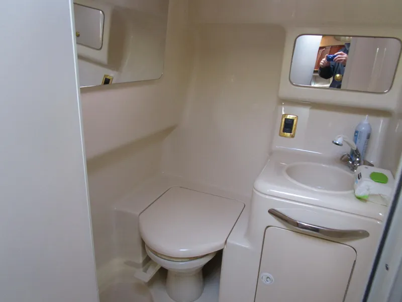 Slide: The Image of Compact bathroom in 2001 Sea Ray 340 Amberjack boat with toilet and sink. - 23