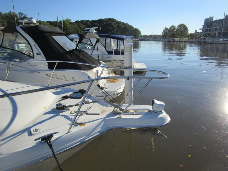 Slide: The Image of 2001 Sea Ray 340 Amberjack docked in a serene marina setting. - 3