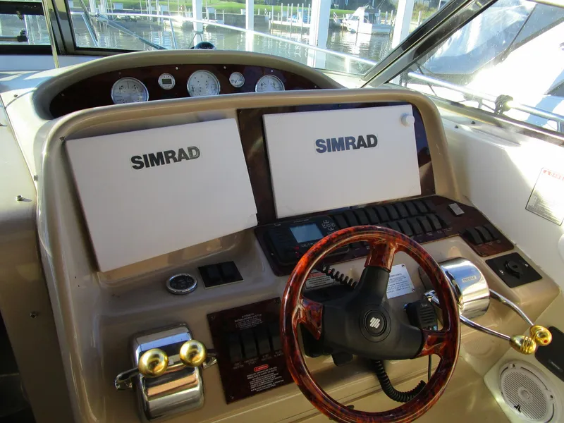 Slide: The Image of Cockpit of 2001 Sea Ray 340 Amberjack with Simrad navigation displays and wood-grain steering wheel. - 4