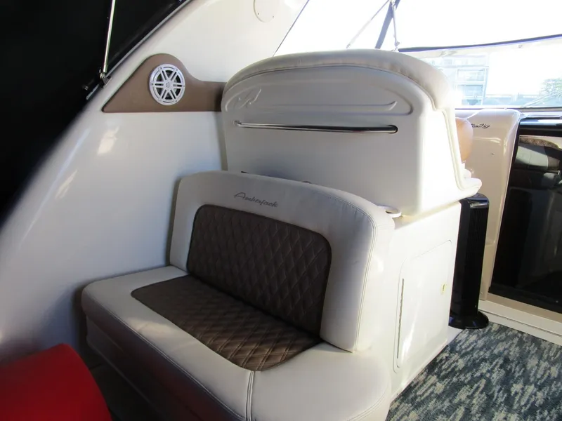 Slide: The Image of Interior seating of 2001 Sea Ray 340 Amberjack boat, featuring cushioned seats and speaker. - 5