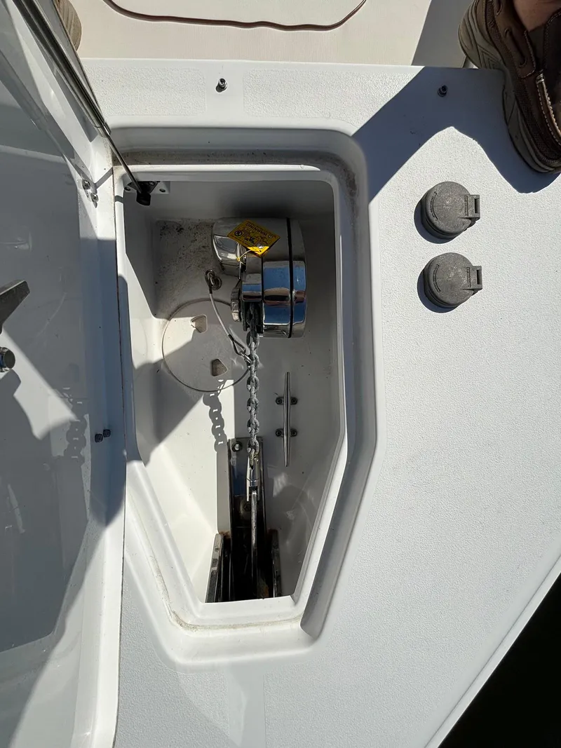 Slide: The Image of Anchor compartment of 2020 Sea Hunt Ultra 275 SE boat with chain and winch. - 11
