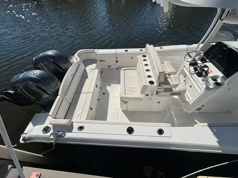 Slide: The Image of 2020 Sea Hunt Ultra 275 SE boat with dual Yamaha engines, spacious seating, and modern controls. - 18