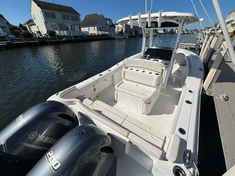 Slide: The Image of 2020 Sea Hunt Ultra 275 SE boat docked, featuring dual Yamaha engines, in a residential canal setting. - 19