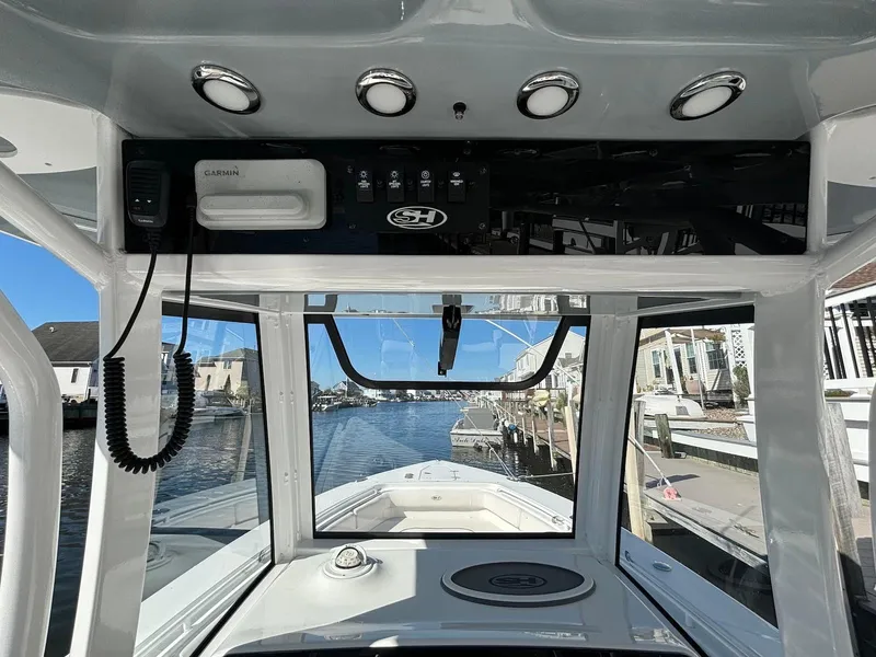 Slide: The Image of Interior view of 2020 Sea Hunt Ultra 275 SE boat cockpit with waterfront background. - 22