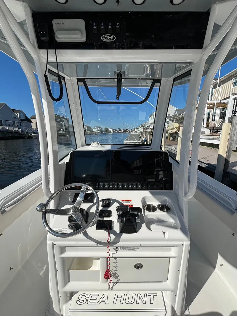 Slide: The Image of 2020 Sea Hunt Ultra 275 SE boat console with steering wheel and navigation equipment. - 23