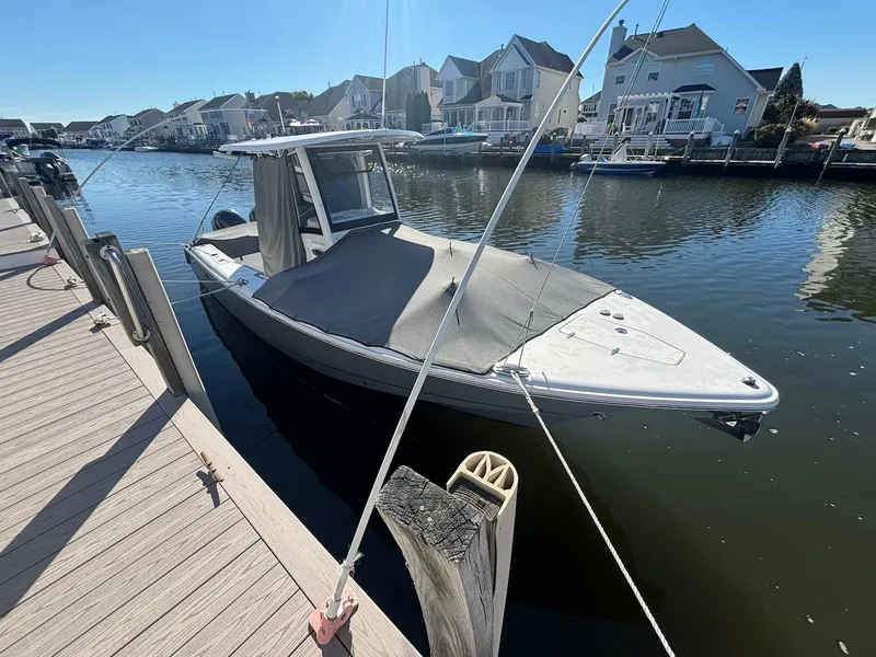Slide: The Image of 2020 Sea Hunt Ultra 275 SE boat docked in a residential canal. - 25