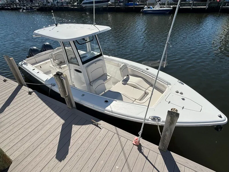 Slide: The Image of 2020 Sea Hunt Ultra 275 SE boat docked at marina, featuring sleek design and spacious deck. - 3