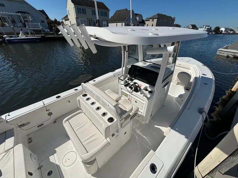 Slide: The Image of 2020 Sea Hunt Ultra 275 SE boat docked by waterfront homes. - 6