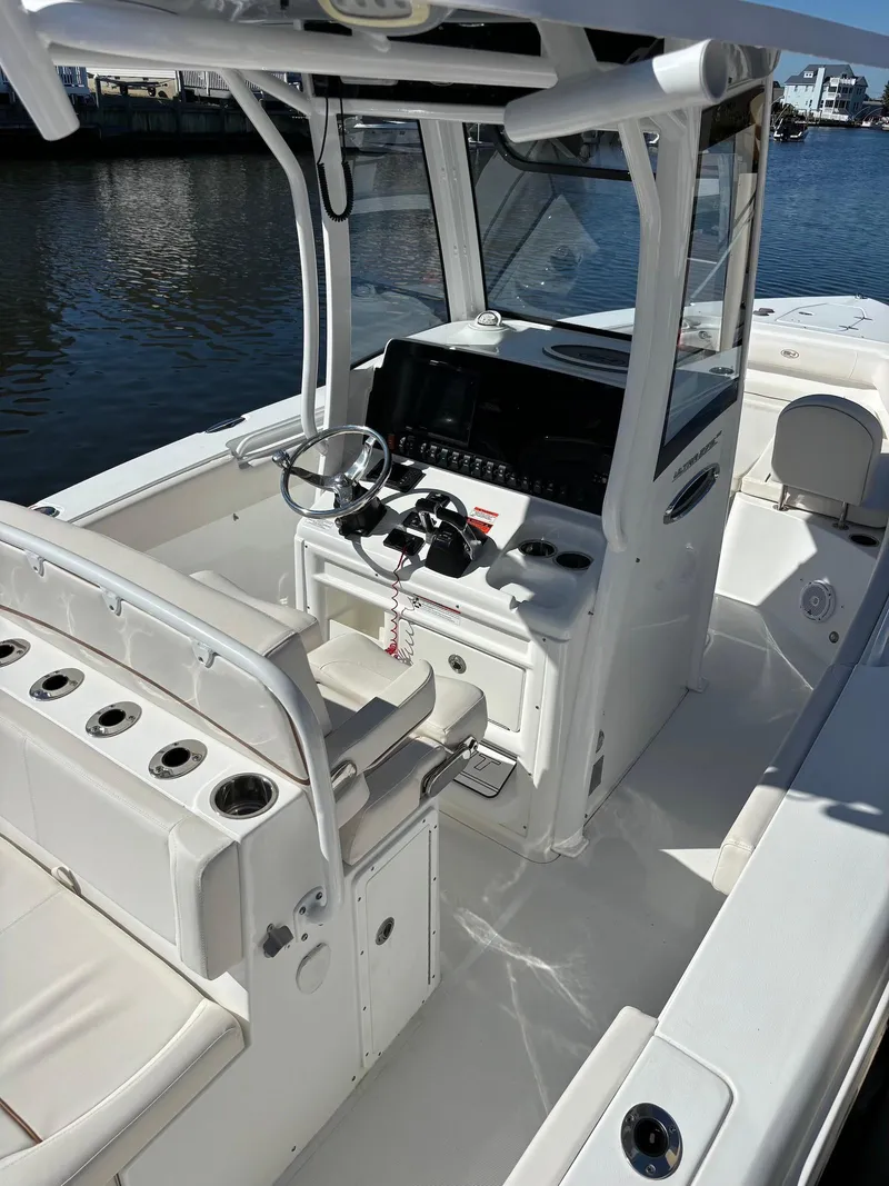 Slide: The Image of 2020 Sea Hunt Ultra 275 SE boat interior with steering console and seating. - 8