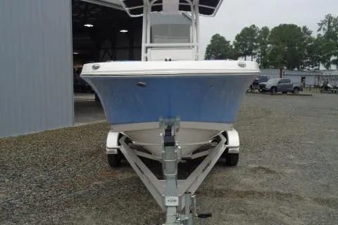 Slide: The Image of 2025 Robalo R200 Center Console boat on trailer, parked outdoors near a building. - 13