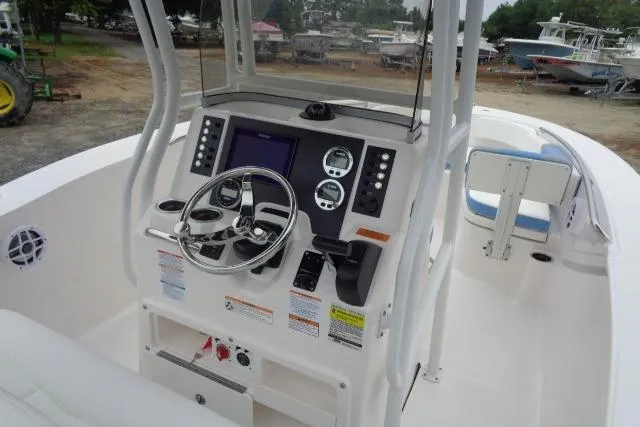 Slide: The Image of 2025 Robalo R200 Center Console boat interior with steering wheel and control panel. - 23