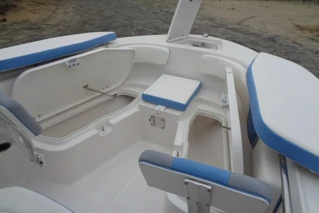 Slide: The Image of 2025 Robalo R200 Center Console boat interior with open storage compartments and seating. - 24