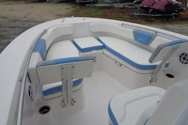 Slide: The Image of 2025 Robalo R200 Center Console boat with white and blue cushioned seating. - 27