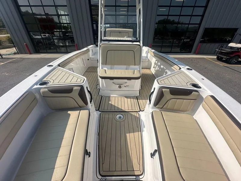 Slide: The Image of 2022 Yamaha Boats 210 FSH® SPORT interior with beige seating and wood accents. - 5