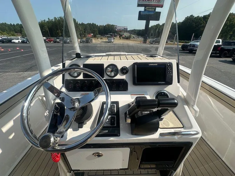 Slide: The Image of 2022 Yamaha Boats 210 FSH® SPORT dashboard with steering wheel and controls. - 6
