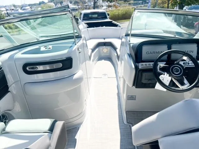 Slide: The Image of 2025 Crownline 290 XSS boat interior with modern dashboard and seating. - 12