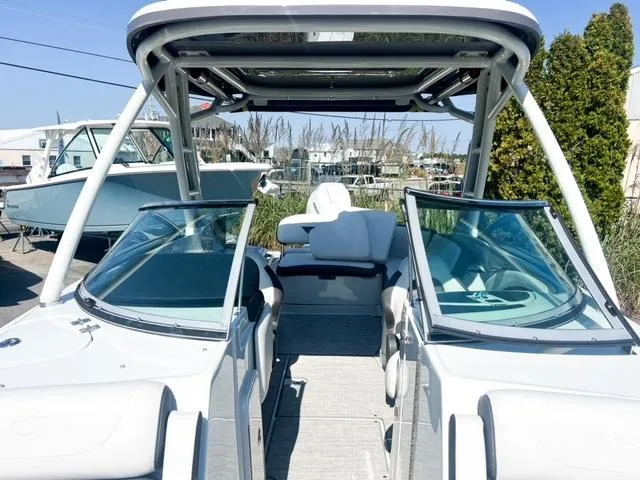 Slide: The Image of 2025 Crownline 290 XSS boat with open cockpit and sleek design. - 13