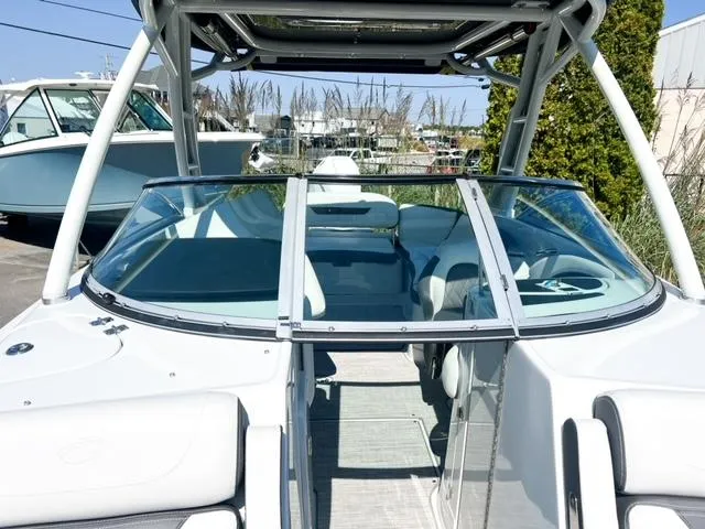 Slide: The Image of 2025 Crownline 290 XSS boat with sleek design and spacious seating. - 14