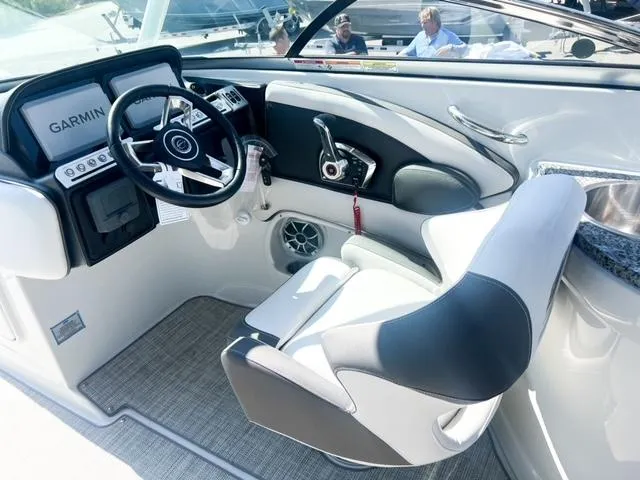 Slide: The Image of 2025 Crownline 290 XSS boat cockpit with Garmin navigation and modern steering wheel. - 15