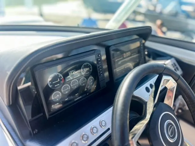 Slide: The Image of Dashboard of 2025 Crownline 290 XSS boat with digital displays and steering wheel. - 16