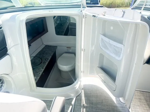 Slide: The Image of 2025 Crownline 290 XSS boat interior with modern bathroom amenities. - 20