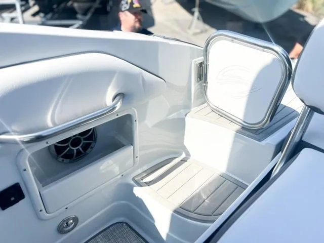 Slide: The Image of 2025 Crownline 290 XSS boat interior with speaker and storage compartment. - 26